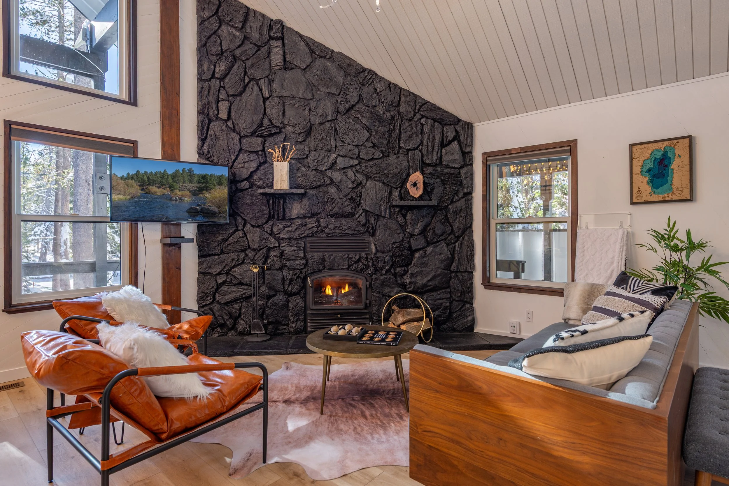 Renovated living room with dramatic stone fireplace
