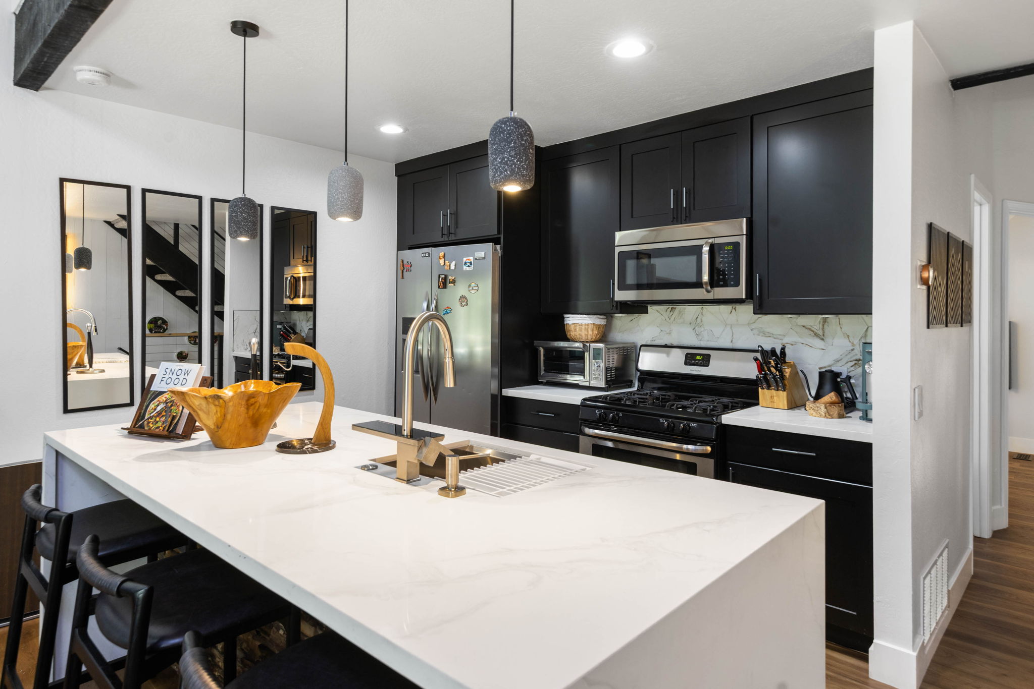 Cubs Manor kitchen after renovation, walnut cabinets and marble island