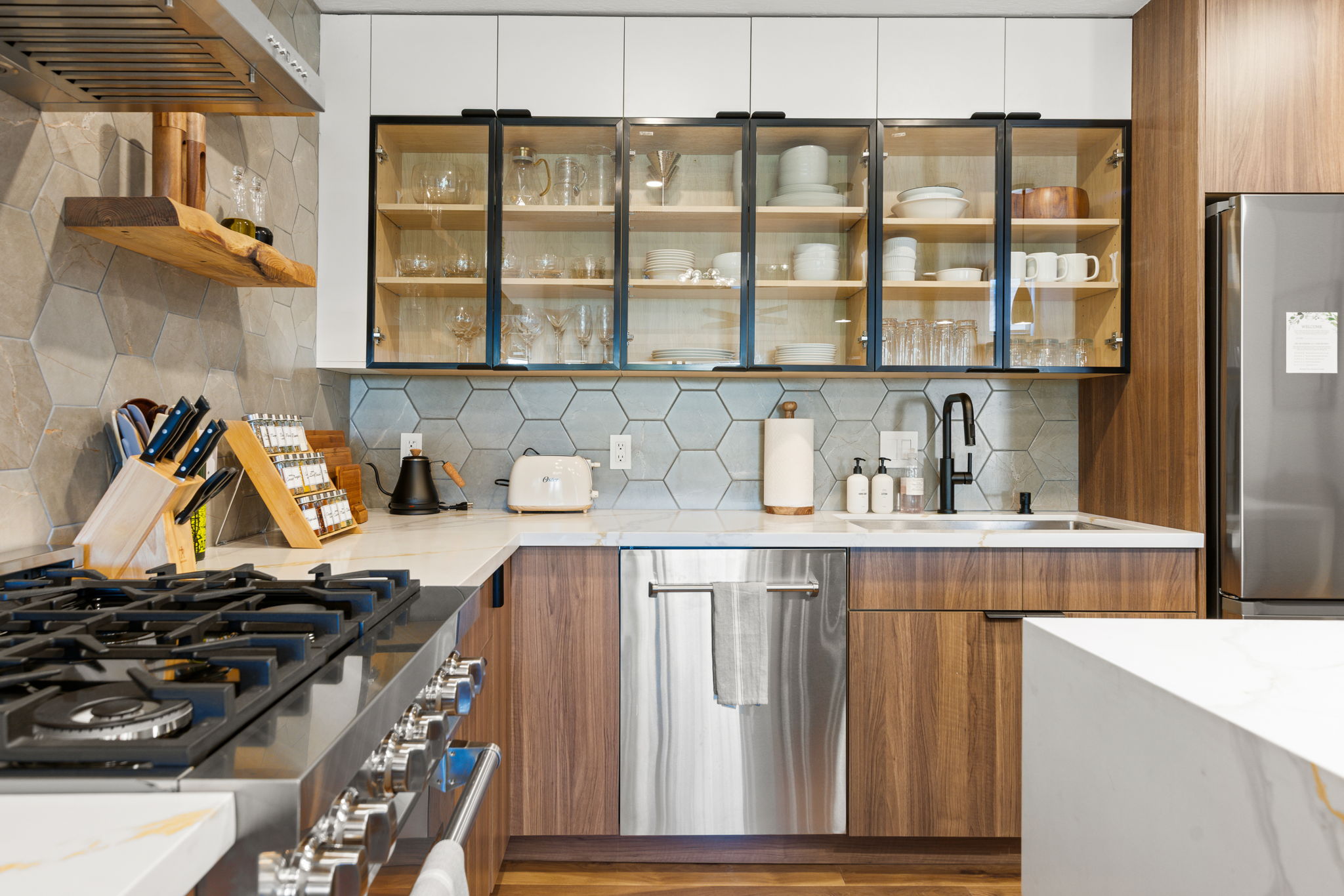 Lake Haus kitchen after renovation, walnut and white cabinets with hex porcelain tile