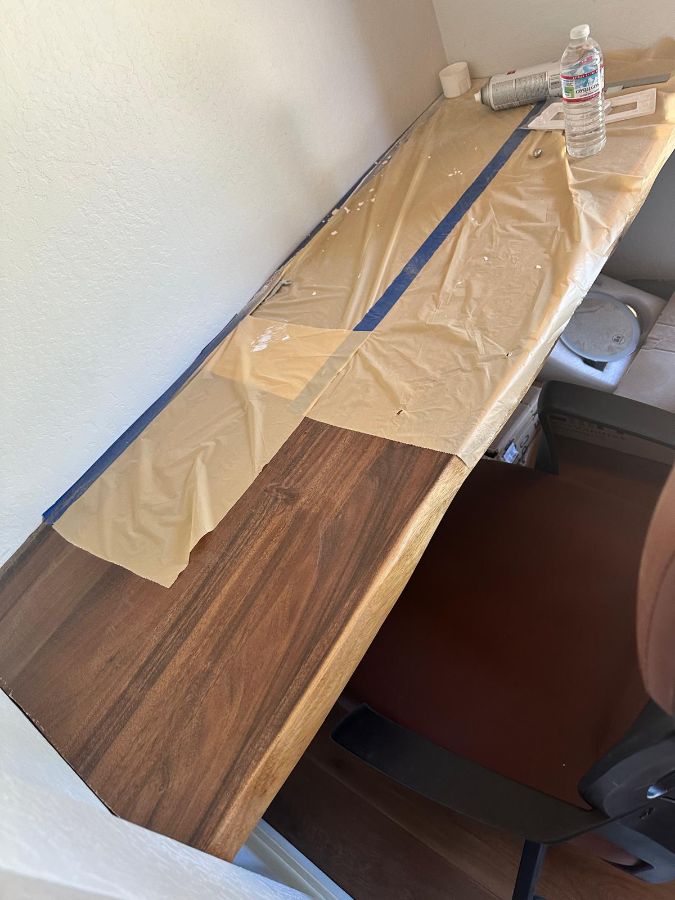 Walnut desk taped for finishing